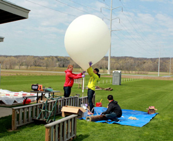 The students ready the weather balloon for a launch.