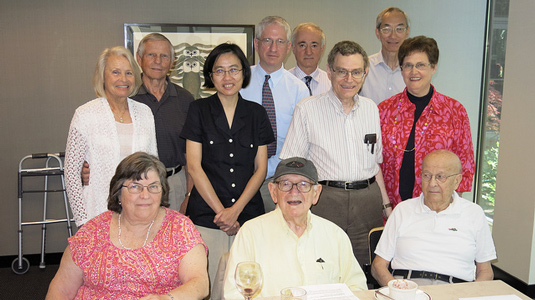 Morris Brodwin (center), emeritus professor of electrical engineering and computer science, is recognized at a luncheon on July 14.