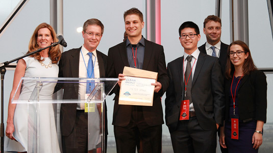 MeterGenius’ Ty Benefiel (center) holds a certificate, which awards the company the $25,000 McCaffrey Interest Prize at the Midwest Regional Clean Energy Challenge. MeterGenius members Yan Man and Hillary Hass (both standing on the right) accept the prize with him.