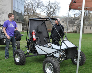 A crowd, including President Morton Schapiro, checks out the 2014 Baja SAE car during its April 24 unveiling.