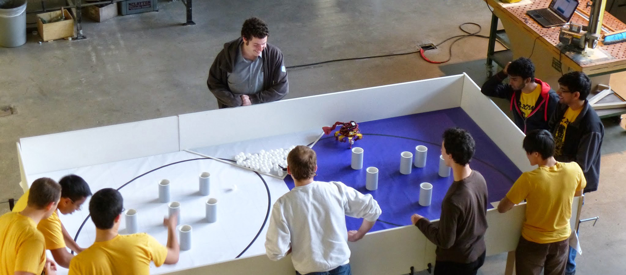 A crowd watches as an autonomous robot attempts to pick up Ping-Pong balls during last year’s Design Competition.