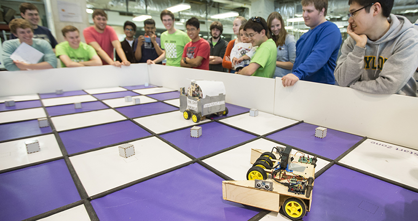Students watch as Veggie Bot competes in Robot Checkers.