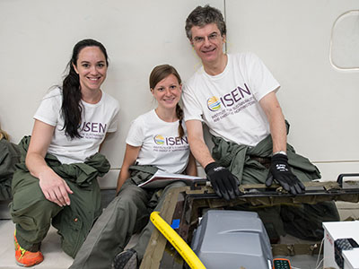 Kristen Scotti, Emily Northard, and David Dunand sit with their freeze-casting equipment during their first flight on the Weightless Wonder.
