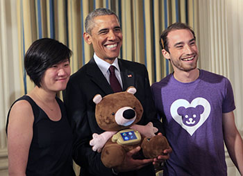 Sproutel co-founders and DFA alumni Hannah Chung and Aaron Horowitz presented Jerry the Bear to President Barack Obama during the first-ever White House Demo Day in 2015.