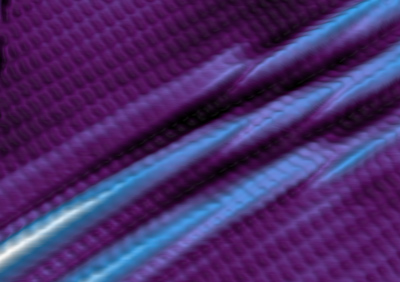 This image shows an atomic-resolution topographic rendering of the borophene surface, taken in the scanning tunneling microscope. The borophene sheet forms large buckled wrinkles, as seen in the center, in response to the underlying silver crystal. These atomic scale wrinkles may serve to steer the flow of electrons and could lead to other surprising properties. (Credit: Andrew Mannix)