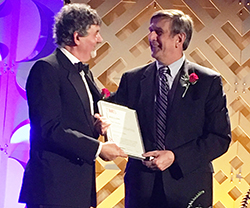 Wessels (right) receives the award from Patrice Turchi, TMS president.