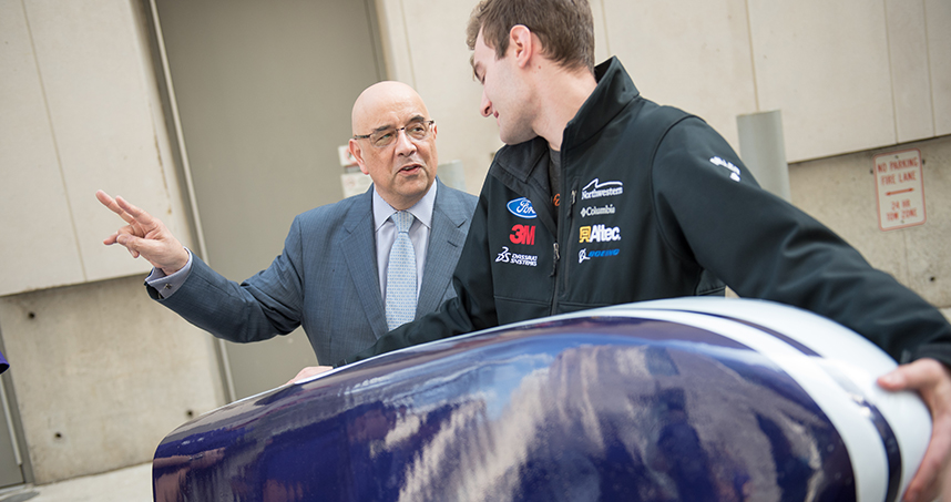 Julio M. Ottino, dean of Northwestern Engineering, talks with members of the Formula team.