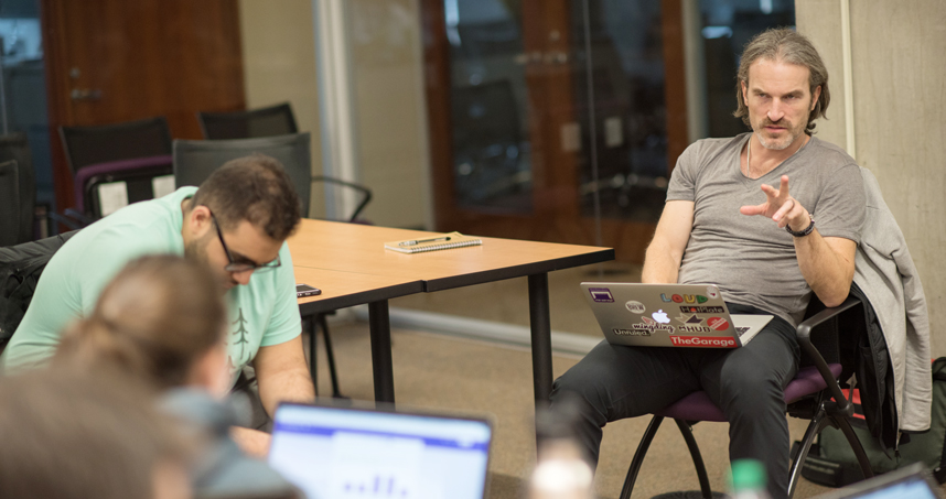 Billy Banks, associate director of The Garage, talks to students.