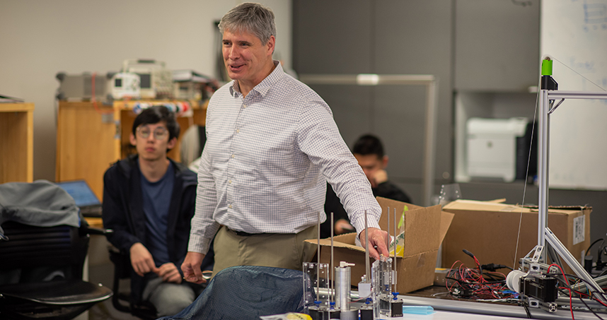Kevin Lynch, chair of mechanical engineering, consulted with students about their robot project. Credit: Rob Hart