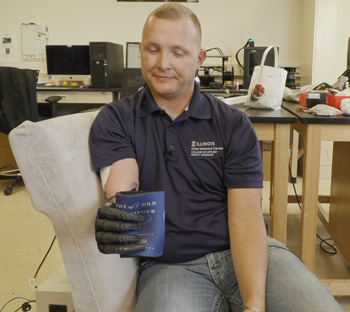 Retired US Army Sgt. Garrett Anderson grabs and grips an object while wearing Northwestern’s wireless patch. Credit: Northwestern University