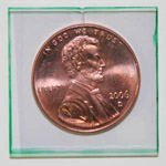 A penny under an array of 70 indium oxide thin film-transistors on .7mm thick glass to demonstrate t