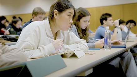 Students taking notes in lecture class
