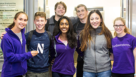 Seven people wearing Northwestern gear