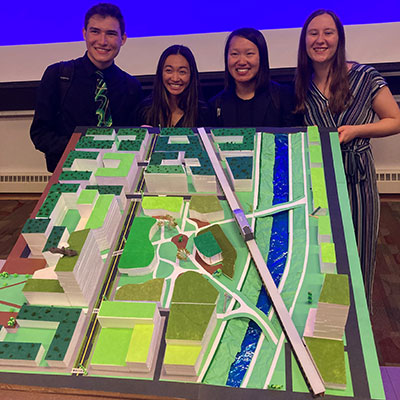 Nick Villareal, Jessica Lee, Emma Novak, and Capstone Award winner Cameron Manning pose with their physical model of the Central Green site