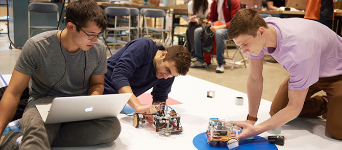 Students get their robot ready before competition.