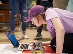A student gets her robot ready for competition.