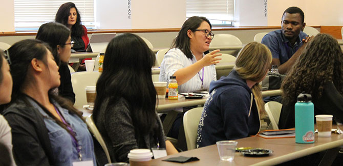 Audience members engage in discussion.