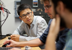 3 students working at a laptop together