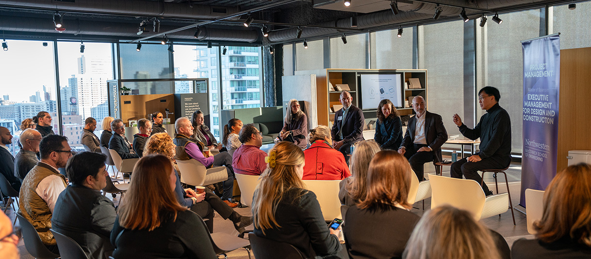 A group of professionals listens as to a panel of experts at a BuiltX event