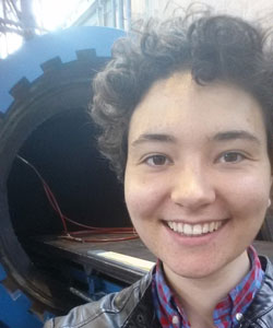 Elizabeth in front of the autoclave, where she helped to construct composite test specimen