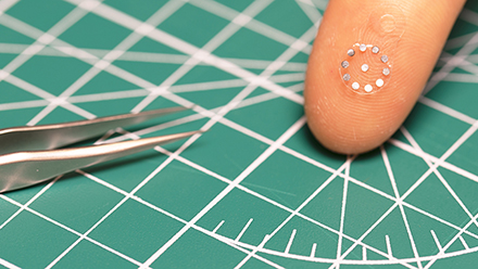 close-up of ultrasound sticker on a finger