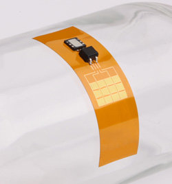 The implant contains a flexible piezoelectric film and a tiny rechargeable battery. (Credit: John Rogers, University of Illinois)