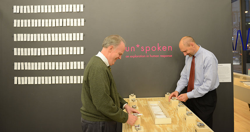 Visitors play music at the Un*spoken exhibit.