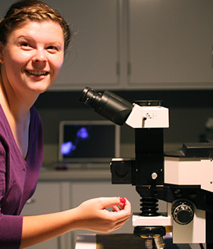 Emilie Campbell examines artwork under a Raman microscope.