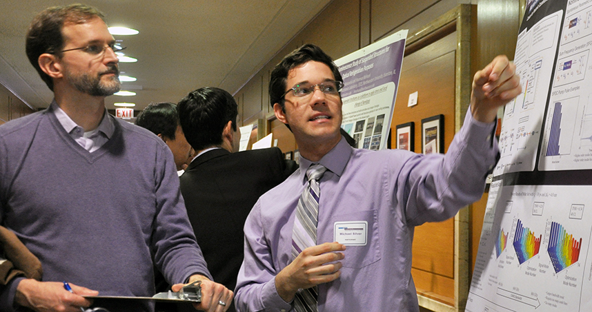 Graduate student Michael Silver (right) explains his project to Professor Matthew Grayson, who served as as judge at the fair.