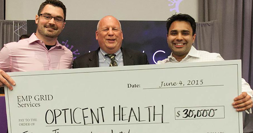 Shane Parkhill (left) and Kieren Patel (right) receive a check from event judge Jack Pressman.