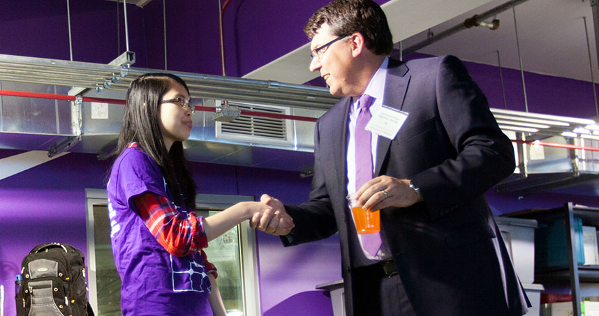 3M's Chris Haas talks with a member of the NUSolar team.