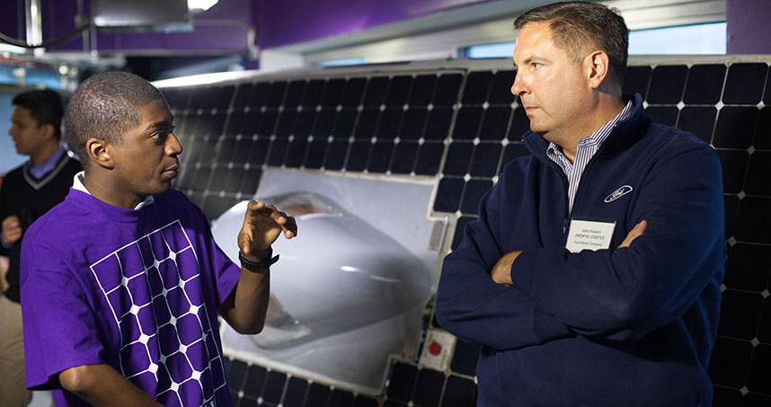 NUSolar's Spencer Williams talks with John Kwant from Ford.