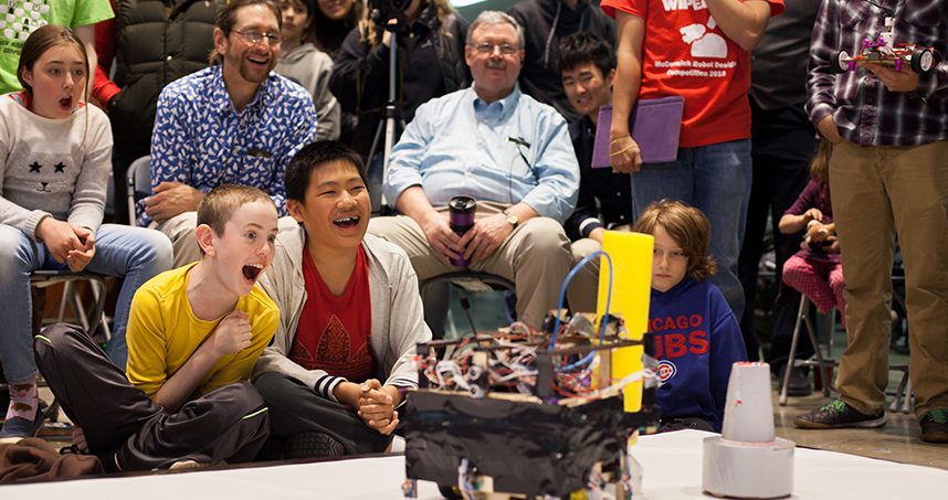 Attendees cheer for their favorite robot.