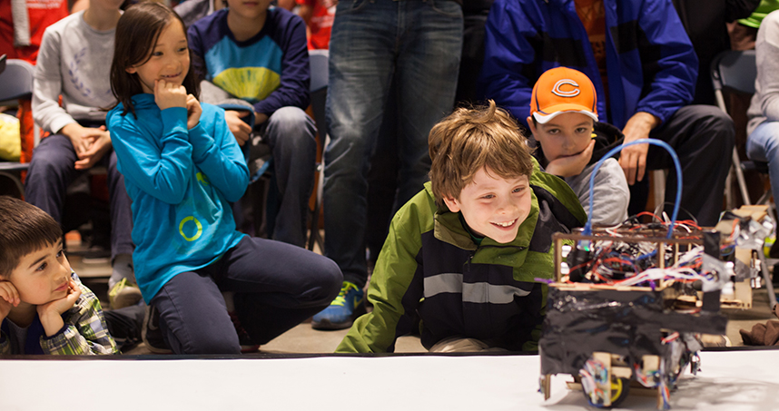 Young attendees take a close look at the autonomous robots.