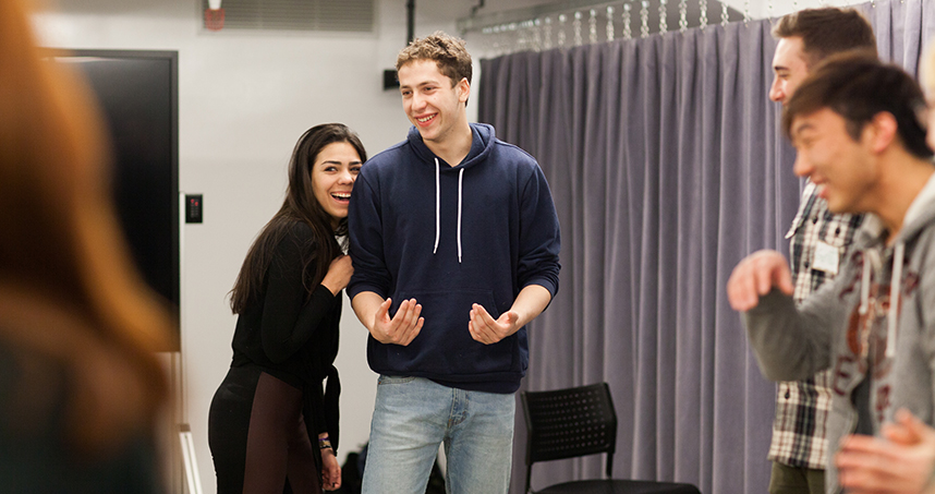 Cansu Seckin and Sam Remler laugh during a class exercise.