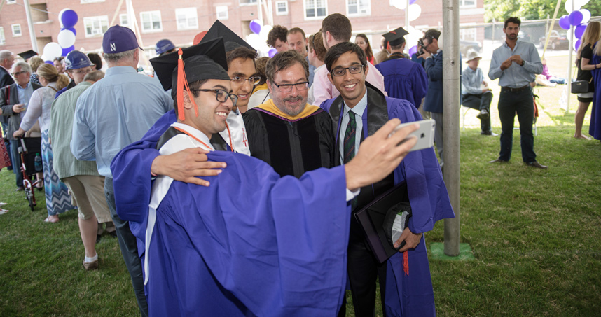 Graduates celebrate with professor Larry Birnbaum.