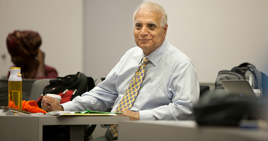 Verinder Syal, the YALI program's lead faculty member, gives feedback during the presentations.