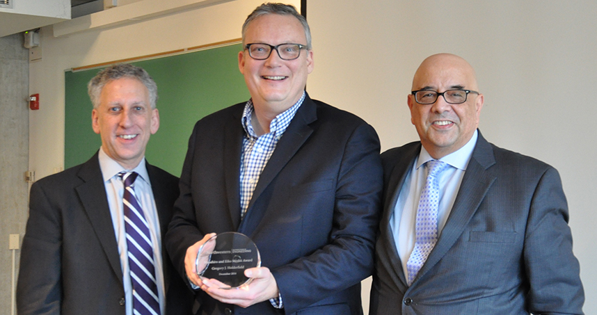 Greg Holderfield (center) stands with University Provost Dan Linzer and Dean Julio M. Ottino