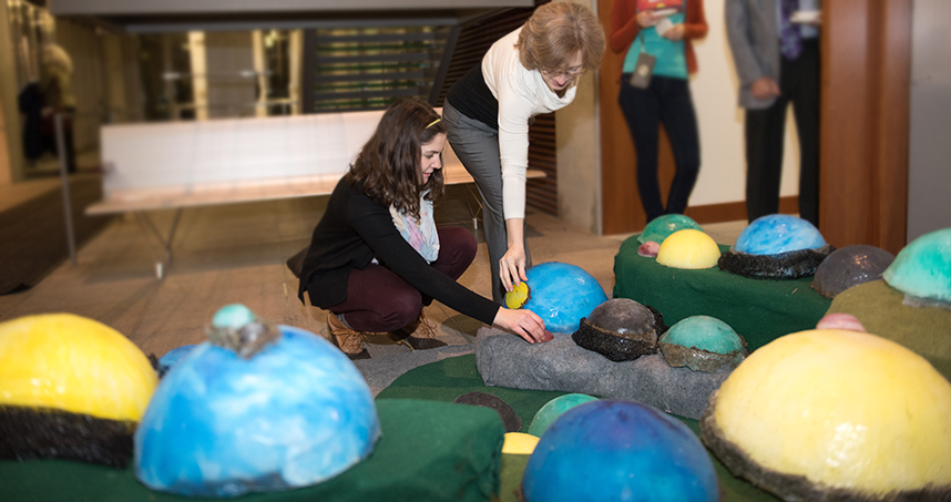 Visitors interact with "Globule," a tapestry representing water quality data from "Bubbly Creek."