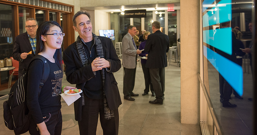 Guests watch messages pop up in the "Serendipity" installation.