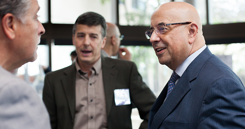 Professor John Rogers and Dean Julio M. Ottino mingle with guests at the post-symposium reception.
