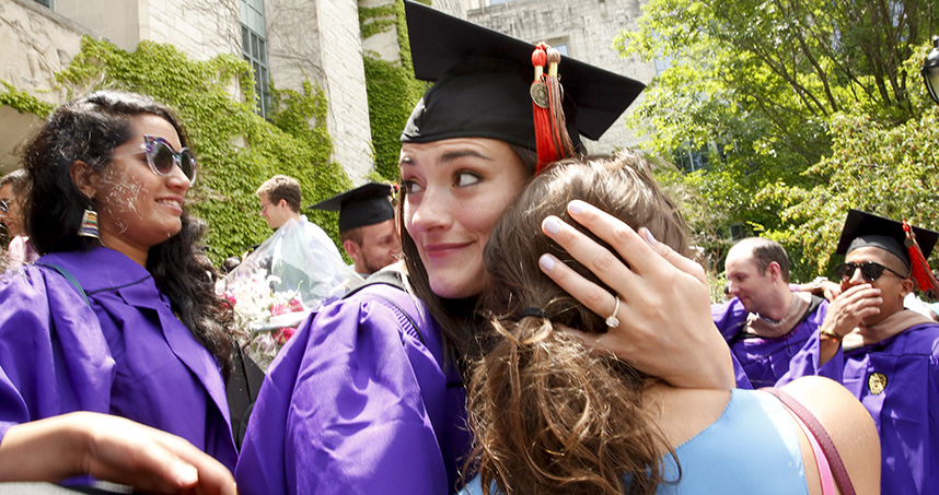 Graduates celebrate after the master's degree ceremonies.