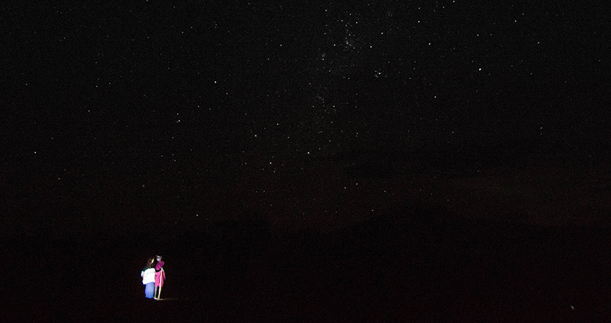 The president of My Chosen Vessels (EWB-NU's NGO partner) stands beneath the stars with a Maasai tribesman.