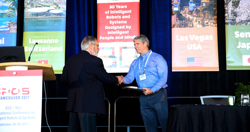 Kevin Lynch accepts the the 2017 IROS Harashima Award for Innovative Technologies.