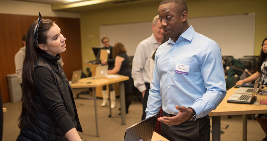 Student Jesse Brown discusses his projects with a guest.