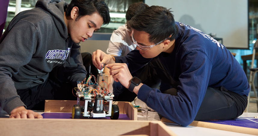 Students work on their robot at Design Competition.