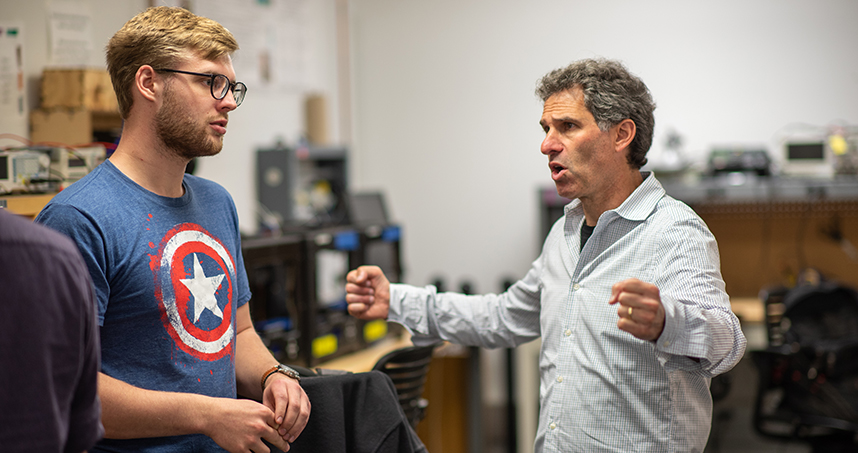 Co-instructor Ron Worth met with the class groups to assist with their robot designs. Credit: Rob Hart
