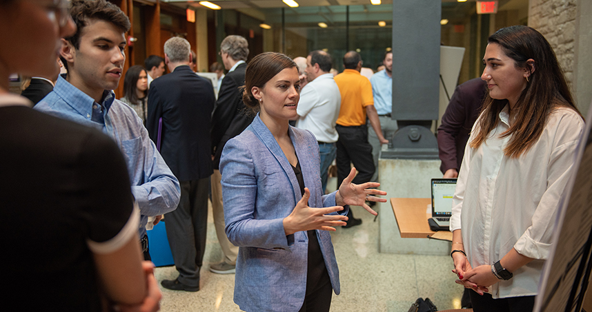 IEMS students fielded questions from client partners and other visitors during the poster session. Credit: Rob Hart