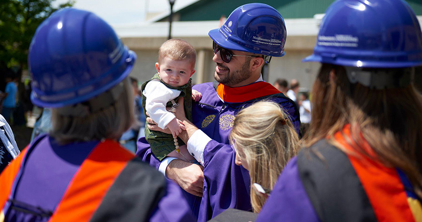A master's graduate celebrates with friends and family after the ceremony on June 22. Credit: Joel Wintermantle