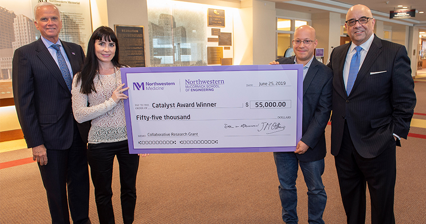 Dean Harrison, Erin Hsu, Jonathan Rivnay, and Dean Julio M. Ottino pose with the Catalyst Award check.